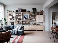 a living room filled with furniture and lots of windows