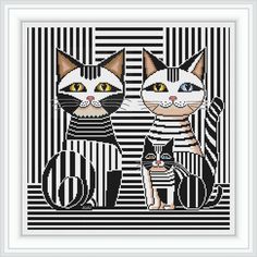 two cats cross stitched together in black and white stripes with one cat looking at the camera