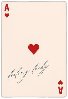 a playing card with two hearts and the words feeling lucky written on it in cursive writing