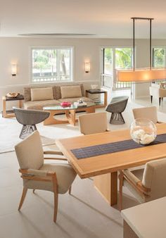 a living room filled with furniture and a dining table in front of a fire place