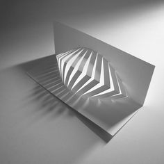 an abstract paper sculpture is shown on the table