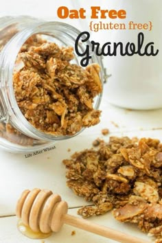 granola in a glass jar next to a wooden spoon with honey on it and the words oat free gluten free granola