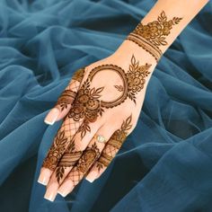 a woman's hand with henna tattoos on it