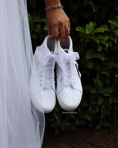 a person wearing white tennis shoes and a veil