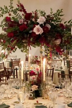 the centerpiece is decorated with flowers and candles for an elegant wedding reception at home