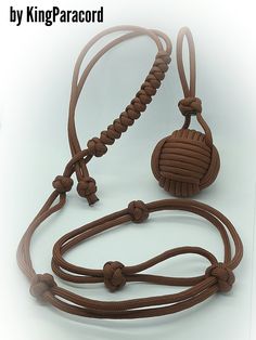 a brown rope with two balls on it