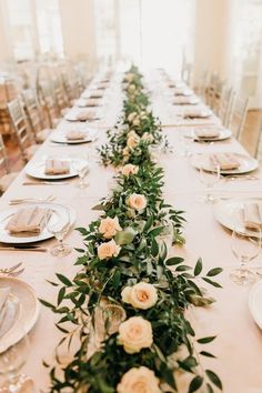 a long table is set with flowers and place settings