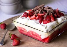 a dessert dish with strawberries and chocolate shavings on the side, ready to be eaten