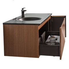 a bathroom sink sitting under a faucet next to a wooden cabinet with drawers