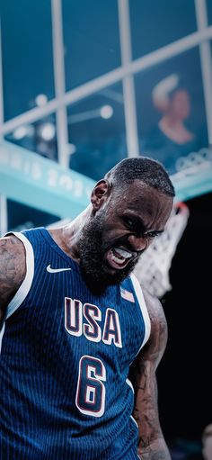 a man with a beard wearing a blue jersey and holding a basketball in his hand