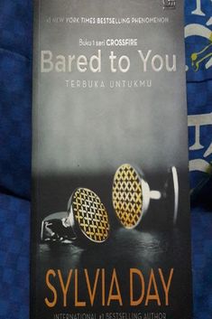 a book on the cover of bared to you by sylvia day