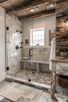 a bathroom with stone flooring and wooden walls, along with a walk in shower