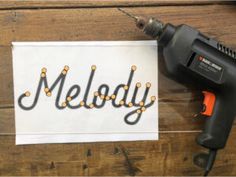 a cordless drill is next to a piece of paper with the word melody on it