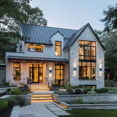 a white house with lots of windows and steps leading up to the front door area