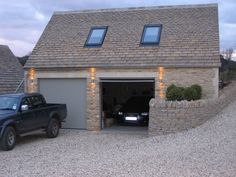 a black truck parked in front of a garage