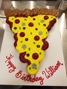 a birthday cake shaped like a slice of pizza