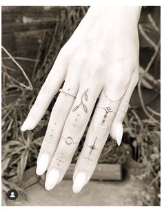 a woman's hand with tattoos on it