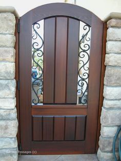 a brown wooden door with wrought iron bars