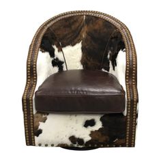 a brown and white cowhide chair with studded trimmings on the back