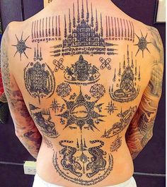 the back of a man with tattoos on his body