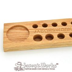 a wooden object with holes in it that says jalon's work on the side