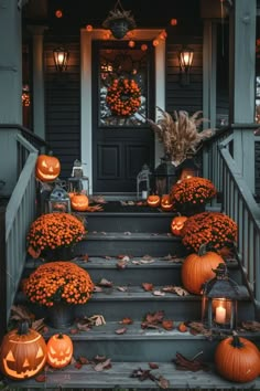 pumpkins and gourds on the steps of a house decorated with lights for halloween