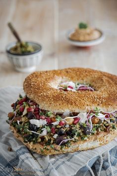 a bagel sitting on top of a table covered in toppings