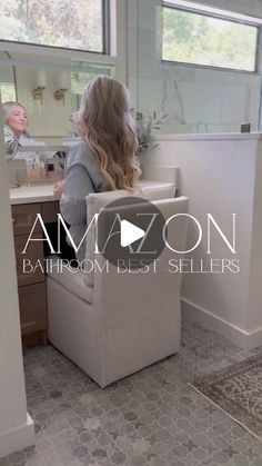 a woman sitting at a bathroom sink in front of a mirror with the words amoon on it