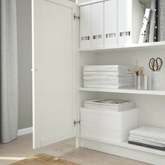 a white book shelf filled with lots of books