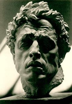 an old photo of a bust of a man with his hair in the middle of his face