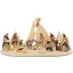 a nativity scene with figurines in the shape of christmas trees and animals