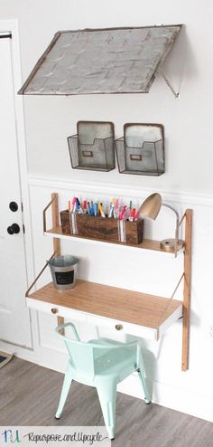 a shelf with some pens and markers on it in front of a white painted wall