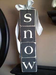 a wooden block with the word snow on it