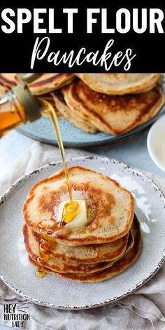 pancakes with syrup being poured onto them on a white plate and text overlay reads, speltt flour pancakes