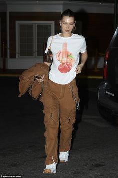 a woman in white shirt and brown pants