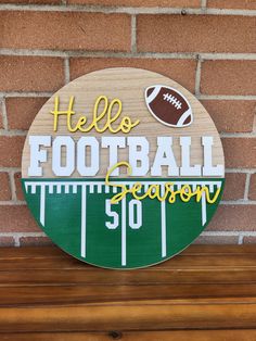 a wooden sign that says hello football season 50