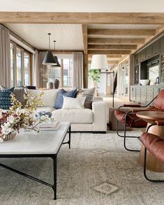 a living room filled with furniture and lots of windows