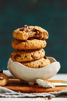 a stack of cookies sitting on top of a white bowl