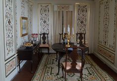 an ornately decorated dining room with fancy wallpaper and rugs on the floor