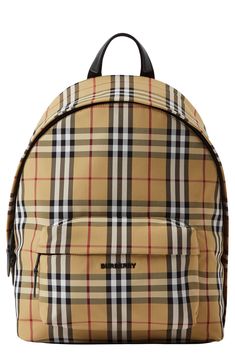 An updated design improves ease of access and stability for this classic nylon-canvas backpack pattered with the iconic house check. Topstitched leather trim adds a polished finishing touch, while a quilted back panel and padded straps offer comfortable carry. Two-way top-zip closure Top carry handle; padded, adjustable backpack straps Exterior zip pocket Interior zip pocket; laptop compartment Textile with leather trim Imported Burberry Backpack, Backpack Reviews, Burberry Shoes, Canvas Backpack, Backpack Straps, Me Time, Leather Trims, Backpack Bags, Zip Pockets