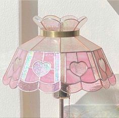 a pink lamp sitting on top of a window sill