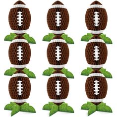 a set of six footballs with grass on top and one in the middle, all decorated