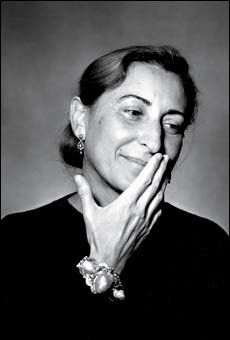 a black and white photo of a woman with her hands on her face, smiling