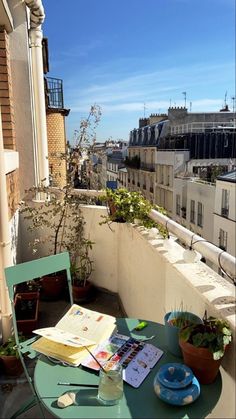 a table and chairs on a balcony overlooking the city