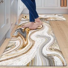 a woman is standing on the floor with her feet up in front of an area rug