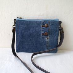 a denim purse with two zippers on the side