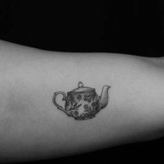 a black and white photo of a teapot tattoo