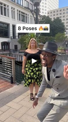 a man in a suit and hat is dancing on the sidewalk with a woman behind him