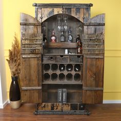 an old wooden cabinet with wine glasses and bottles