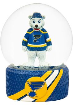 a snow globe with a hockey player in the center and an image of a polar bear inside